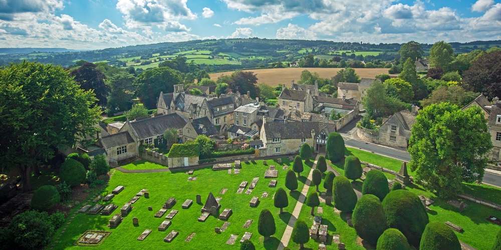 Painswick, The Cotswolds, Gloucestershire, UK, 08.20.2012, an aerial view of the countryside around St Marys church with Yew trees and table tombs.