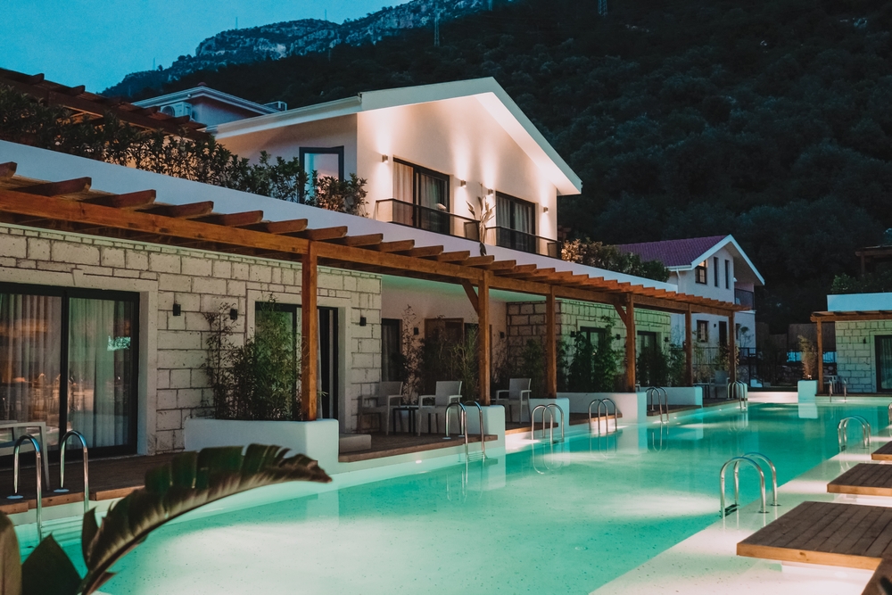 A front view of a boutique hotel's pool