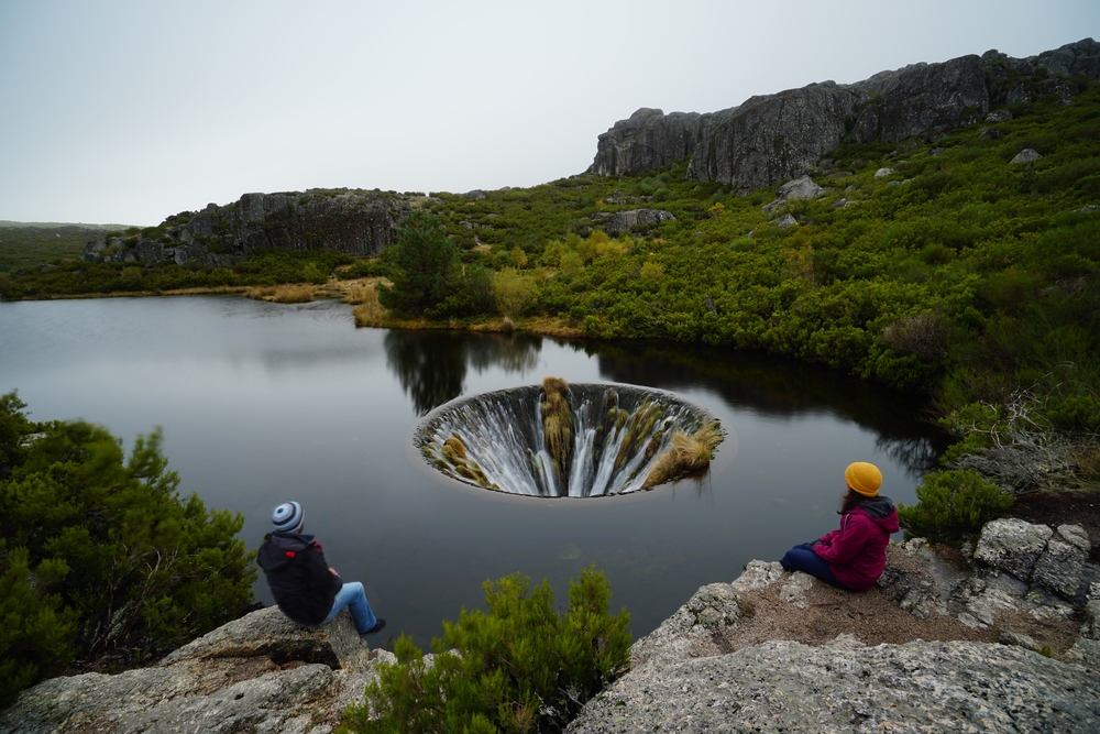 Lake Covao dos Conchos famous for its Bell-mouth spillway in Serra da Estrela mountains, Portugal