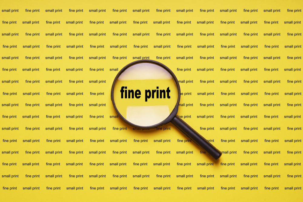 fine print enlarged with magnifying glass magnifier loupe, business concept