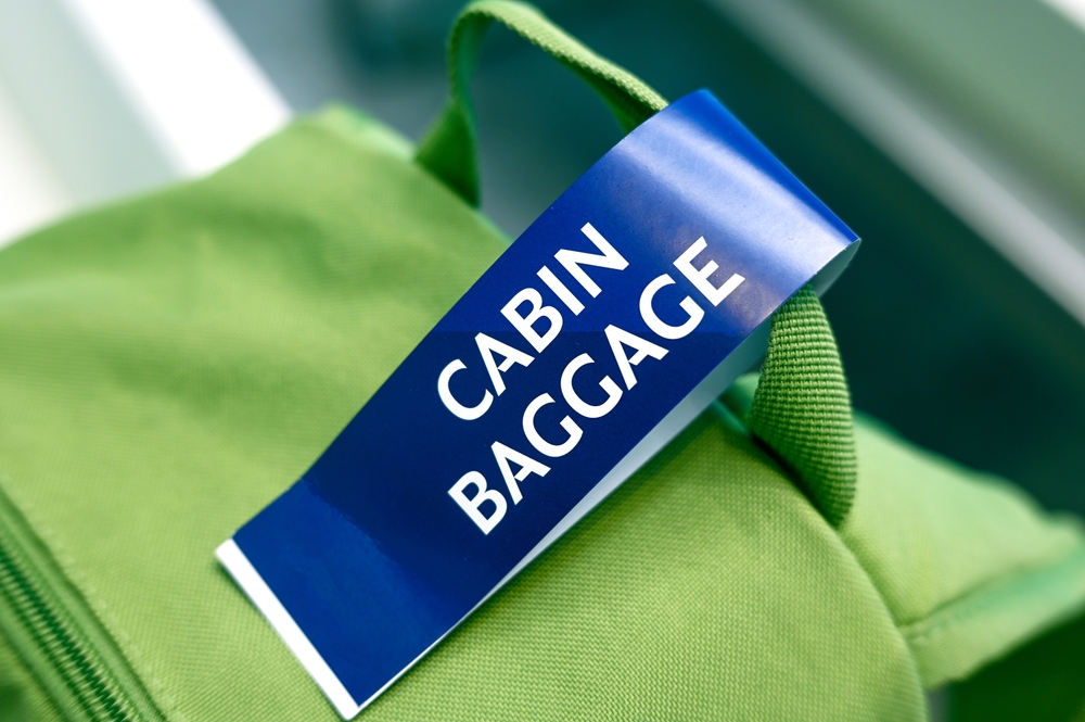 Cabin baggage close-up of tag on green backpack at the airport