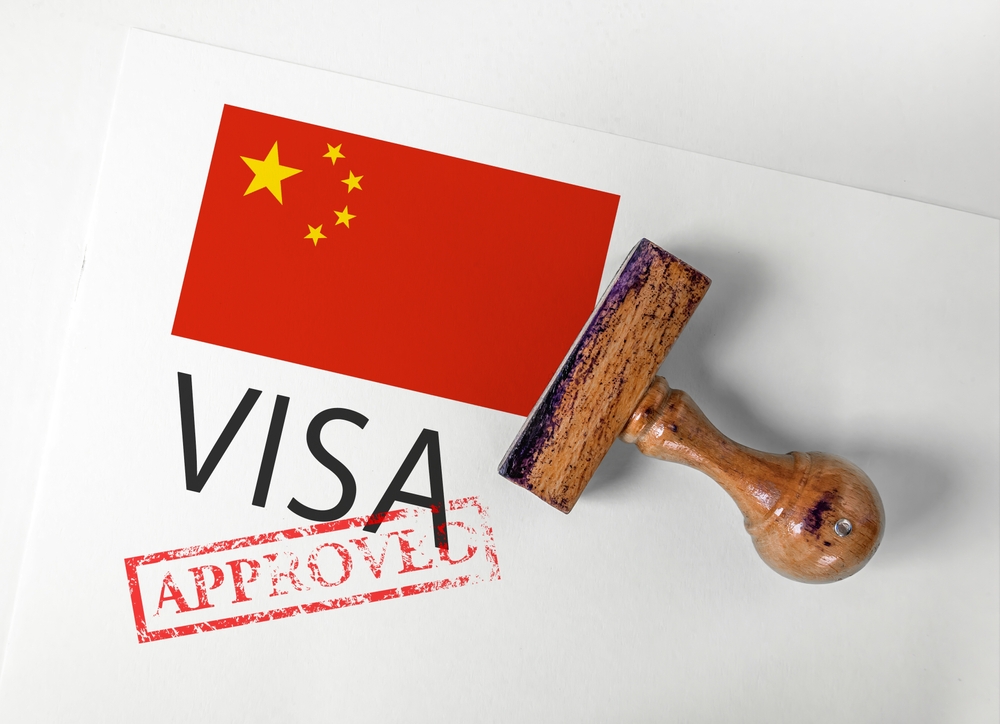 China Visa Approved with Rubber Stamp and flag