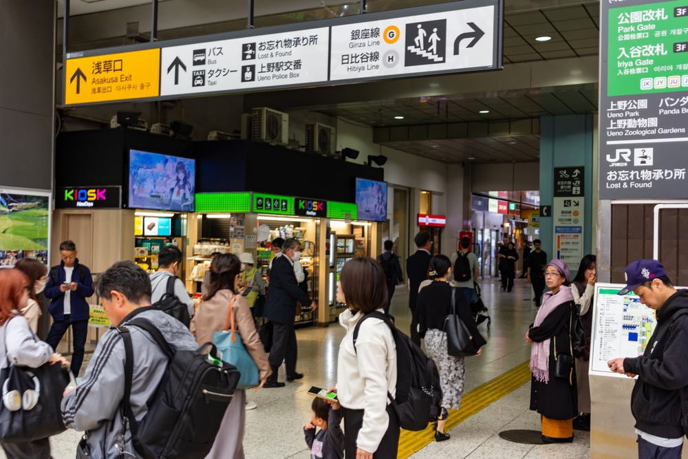Busy Passageway at Ueno Station with Directional Signs to Asakusa and Park Gate